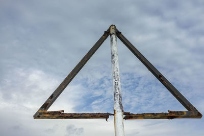 Low angle view of crane against sky