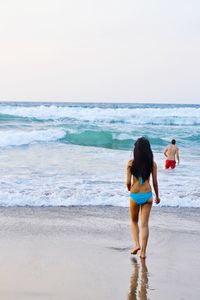 Rear view of people on beach