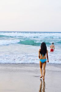 Rear view of people on beach