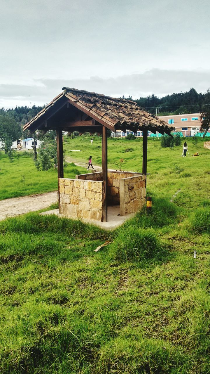 grass, sky, grassy, tranquility, tranquil scene, field, scenics, mountain, green color, nature, cloud - sky, beauty in nature, landscape, relaxation, bench, built structure, grassland, water, day