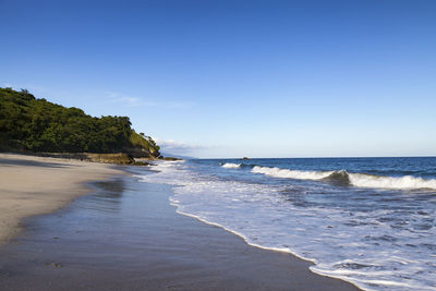 View of beach against blue sky