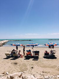 Scenic view of beach against blue sky