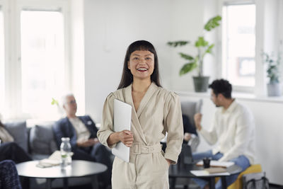 Smiling woman in office looking at camera