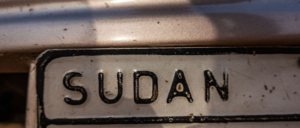 Close-up view of a license plate with the inscription sudan