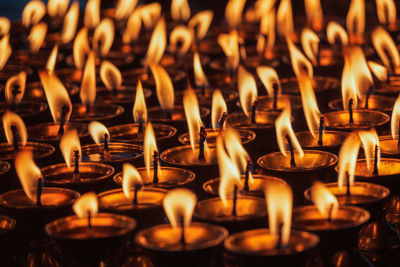 Burning candles in buddhist temple