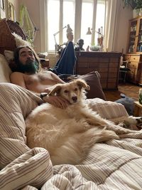 High angle view of dog relaxing on bed at home