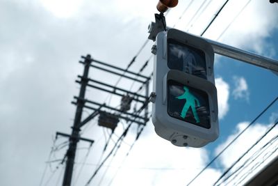 Low angle view of road signal against sky