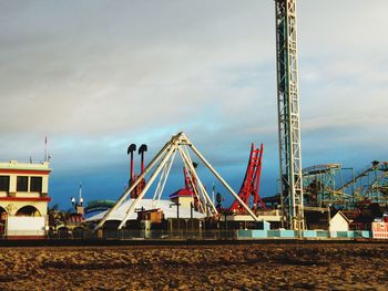 Cranes at construction site against sky