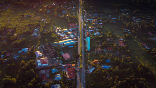 High angle view of illuminated street amidst buildings at night