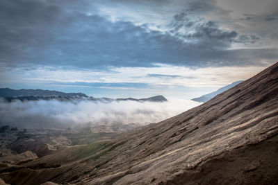 View of mountain range against cloudy sky