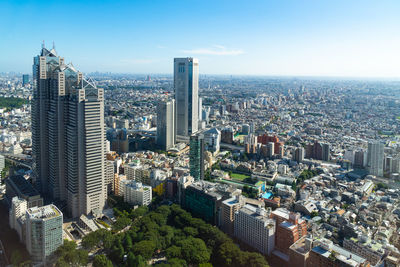 Aerial view of modern buildings in city against sky