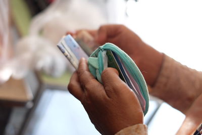 Cropped hand holding paper currencies