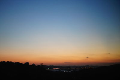 Scenic view of silhouette landscape against clear sky at sunset