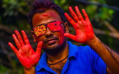 Portrait of a male happy indian celebrating holi with powder paint. concept of indian festival holi.