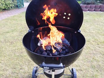 High angle view of coals burning on barbecue grill in back yard