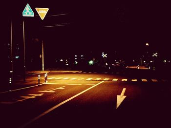 View of illuminated street lights at night