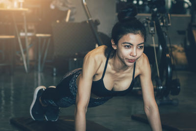 Woman doing push-ups in gym
