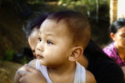 Close-up portrait of cute baby looking away