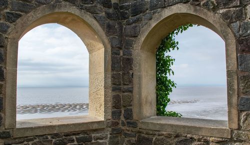 Scenic view of sea against sky seen through window