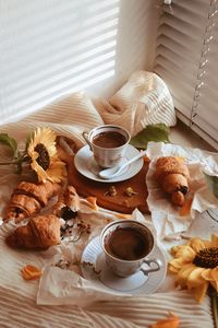 Coffee and cup of breakfast on table