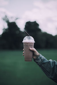 Human hand holding ice cream