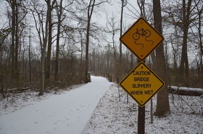 Information sign on snow covered road