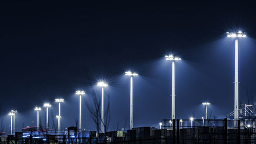 View of illuminated street light against blue sky