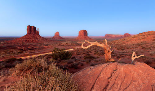 Scenic view of rock formations against clear blue sky