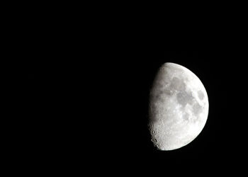 Low angle view of moon against clear sky at night