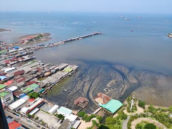 High angle view of buildings by sea