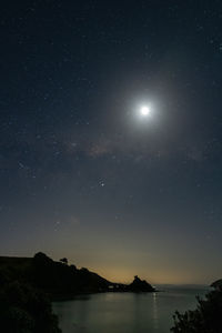 Scenic view of lake against sky at night