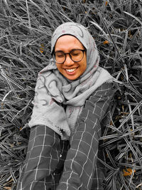 Portrait of smiling young woman standing on field