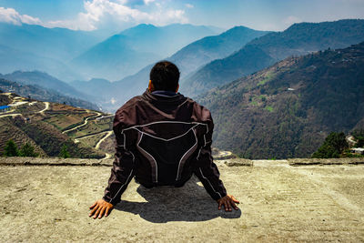 Rear view of man looking at mountain range