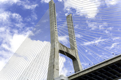 Low angle view of vasco da gama bridge against sky