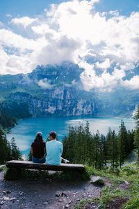 Rear view of people looking at view of mountains