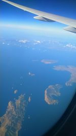 Aerial view of sea and airplane wing