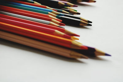 Close-up of colored pencils on white background