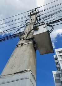 Low angle view of electricity pylon against sky