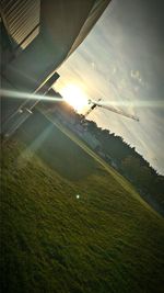 Scenic view of grass against sky during sunset