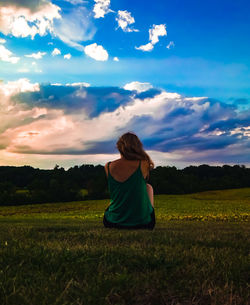 Rear view of woman looking at field