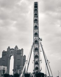 Low angle view of buildings against cloudy sky