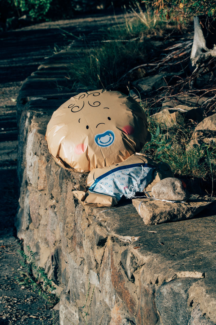 HIGH ANGLE VIEW OF GRAFFITI ON ROCK