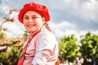 Portrait of a smiling young woman wearing beret on a sunny day