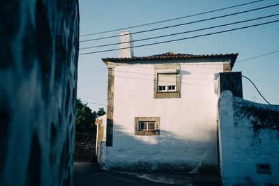 View of houses against clear blue sky