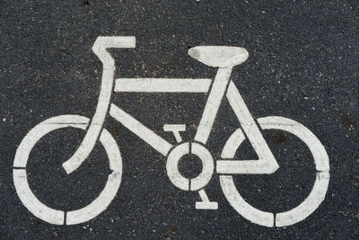 Directly above shot of bicycle lane sign on road