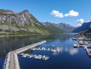Scenic view of lake by mountains against sky