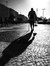 Woman walking on footpath