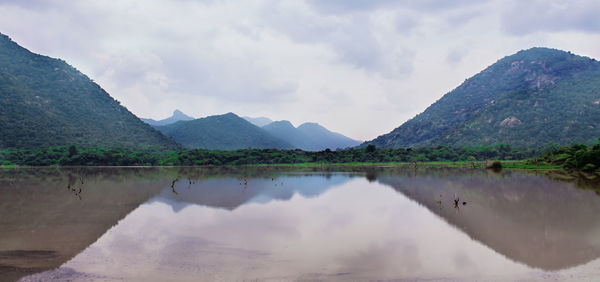 Scenic view of lake and mountains against sky