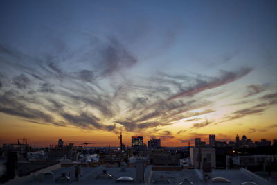 Silhouette of cityscape of buildings against sky