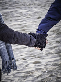 Cropped image of couple holding hands